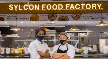 happy employees standing IN front of sylcon food factory