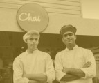 two chef standing IN front of the sylcon chai house