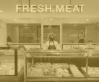a employee standing in the meat section