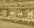 four chef standing inside the food factory
